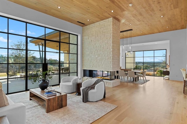 1047 Overlook Pkwy, Horseshoe Bay, TX 78657 - living area with wooden ceiling, a high ceiling, wood finished floors, recessed lighting, and a multi sided fireplace