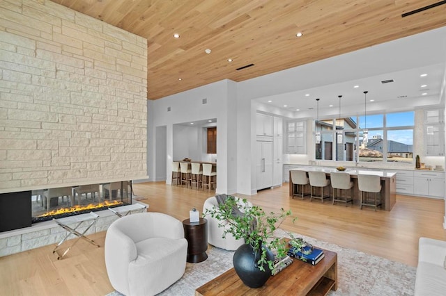 1047 Overlook Pkwy, Horseshoe Bay, TX 78657 - living area featuring wooden ceiling, light wood-style flooring, a fireplace, and recessed lighting