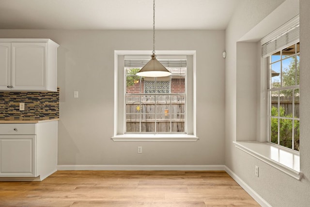 10804 N Canoa Hills Trl, Austin, TX 78717 - unfurnished dining area featuring light wood-style floors and baseboards