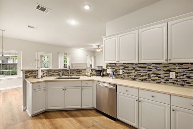 10804 N Canoa Hills Trl, Austin, TX 78717 - kitchen featuring stainless steel dishwasher, a sink, a peninsula, recessed lighting, and tasteful backsplash
