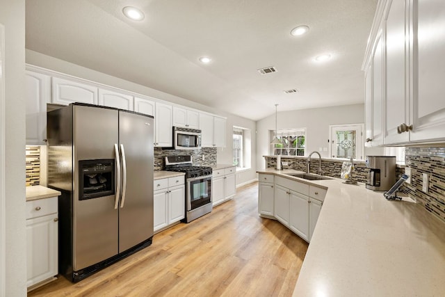 10804 N Canoa Hills Trl, Austin, TX 78717 - kitchen with stainless steel appliances, a sink, tasteful backsplash, white cabinetry, and recessed lighting