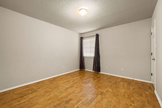 10804 N Canoa Hills Trl, Austin, TX 78717 - unfurnished room with a textured ceiling, baseboards, and light wood-style flooring