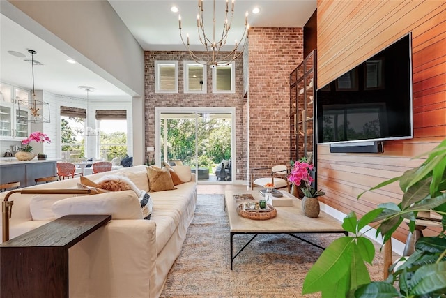 12404 Cardinal Flower Dr, Austin, TX 78739 - living area with a chandelier, brick wall, a towering ceiling, and recessed lighting