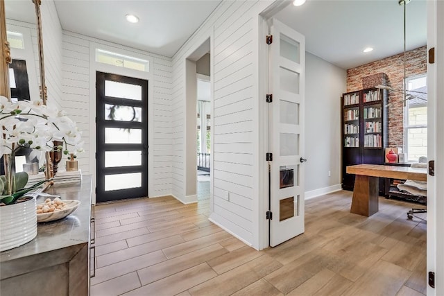12404 Cardinal Flower Dr, Austin, TX 78739 - entrance foyer featuring light wood-type flooring, brick wall, and baseboards