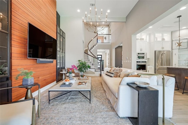 12404 Cardinal Flower Dr, Austin, TX 78739 - living room featuring stairs, a chandelier, recessed lighting, and light wood-type flooring