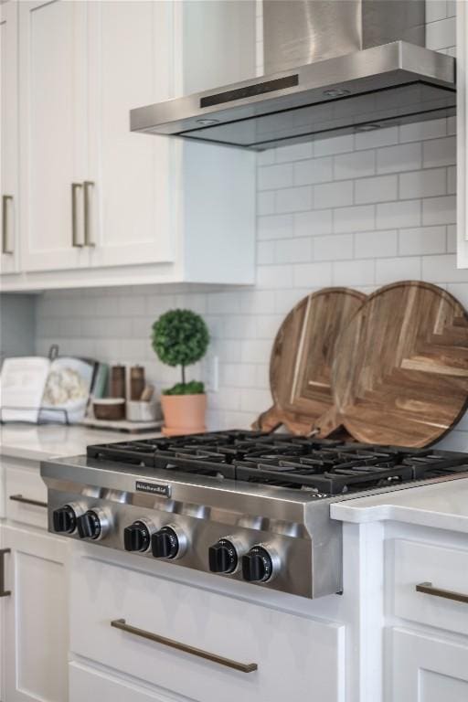 12404 Cardinal Flower Dr, Austin, TX 78739 - kitchen view of wall chimney exhaust hood, stainless steel gas cooktop, light countertops, and tasteful backsplash