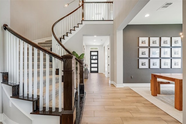 12404 Cardinal Flower Dr, Austin, TX 78739 - entryway with wood finish floors, stairs, a high ceiling, and recessed lighting