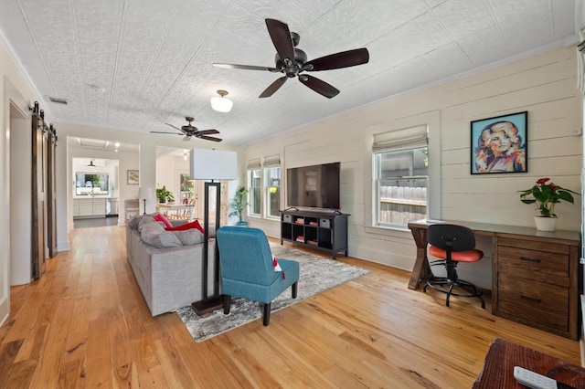 1700 S 3rd St, Austin, TX 78704 - living room with light wood-style floors, an office area, ornamental molding, and a ceiling fan
