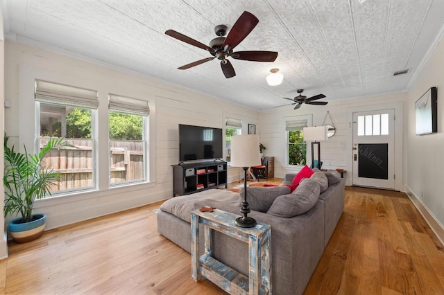 1700 S 3rd St, Austin, TX 78704 - living area with ornamental molding, wood-type flooring, a ceiling fan, an ornate ceiling, and baseboards