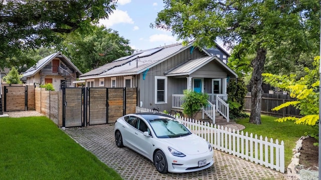 1700 S 3rd St, Austin, TX 78704 - bungalow-style home with a gate, a porch, board and batten siding, and metal roof