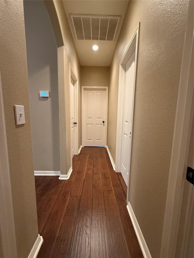 2222 Garden Gate Cir, New Braunfels, TX 78130 - hall featuring dark wood-type flooring, arched walkways, and a textured wall