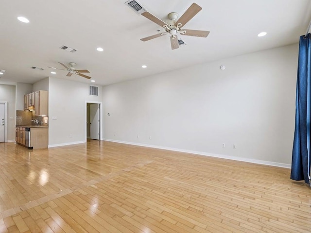 2931 E 12th St Unit 206, Austin, TX 78702 - unfurnished living room with a ceiling fan, light wood finished floors, recessed lighting, and baseboards