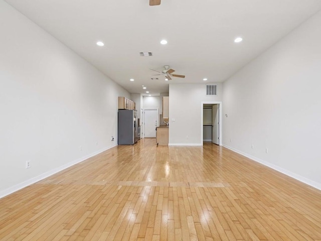 2931 E 12th St Unit 206, Austin, TX 78702 - unfurnished living room featuring ceiling fan, light wood-style floors, baseboards, and recessed lighting