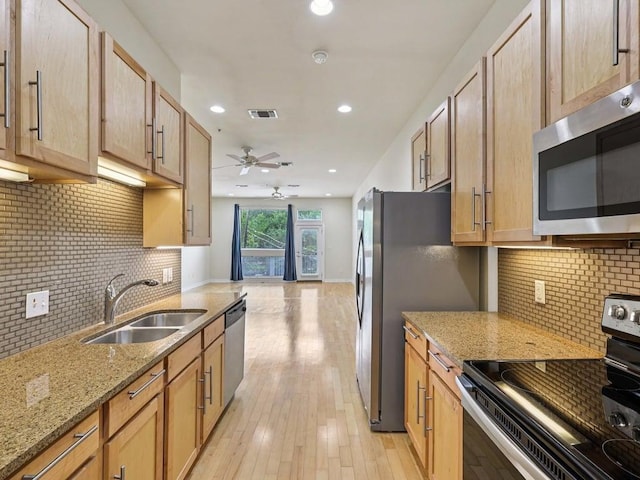 2931 E 12th St Unit 206, Austin, TX 78702 - kitchen featuring appliances with stainless steel finishes, a sink, ceiling fan, backsplash, and recessed lighting