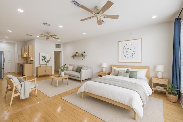 2931 E 12th St Unit 206, Austin, TX 78702 - bedroom featuring freestanding refrigerator, light wood-type flooring, and recessed lighting