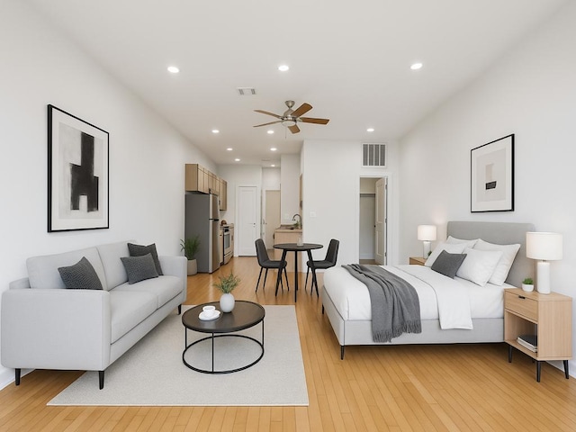2931 E 12th St Unit 206, Austin, TX 78702 - bedroom featuring freestanding refrigerator, light wood-type flooring, a sink, and recessed lighting