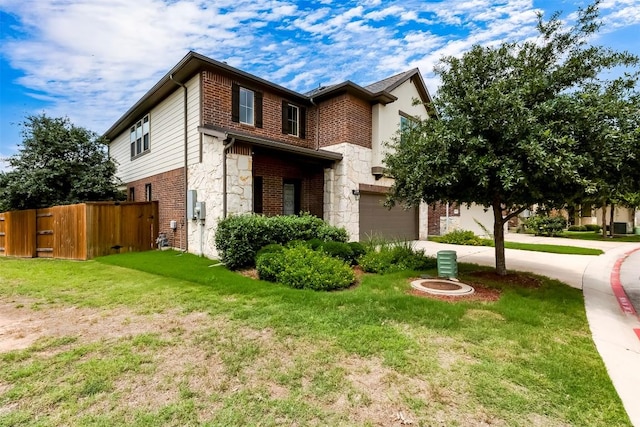 14400 Mccoy Loop, Austin, TX 78717 - view of front of home featuring stone siding, concrete driveway, a garage, and brick siding