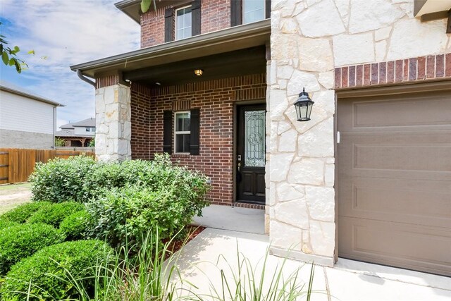 14400 Mccoy Loop, Austin, TX 78717 - property entrance with stone siding, brick siding, and a garage