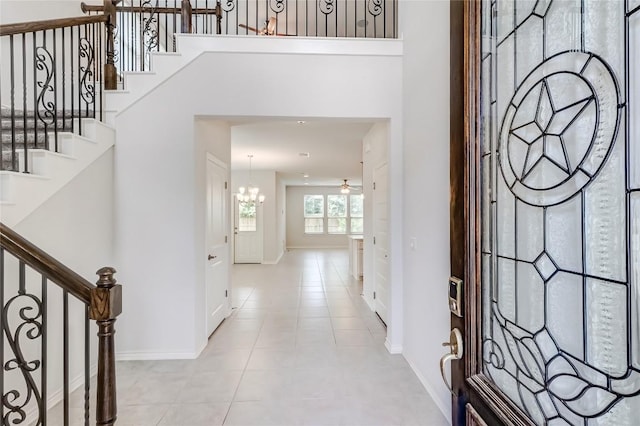 14400 Mccoy Loop, Austin, TX 78717 - entryway featuring a chandelier, baseboards, stairway, and light tile patterned flooring