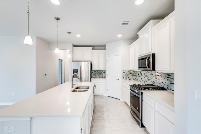 14400 Mccoy Loop, Austin, TX 78717 - kitchen featuring stainless steel appliances, a sink, decorative backsplash, an island with sink, and light countertops