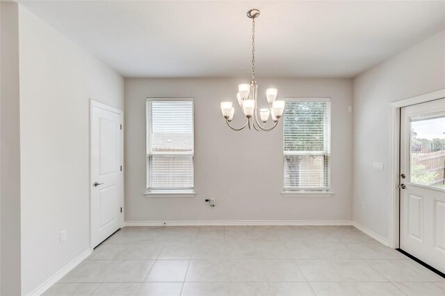 14400 Mccoy Loop, Austin, TX 78717 - unfurnished dining area featuring a chandelier, light tile patterned floors, and baseboards
