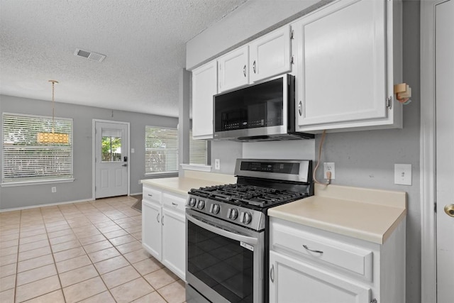 913 Dover Pass, Cedar Park, TX 78613 - kitchen with appliances with stainless steel finishes, light countertops, a textured ceiling, and white cabinetry