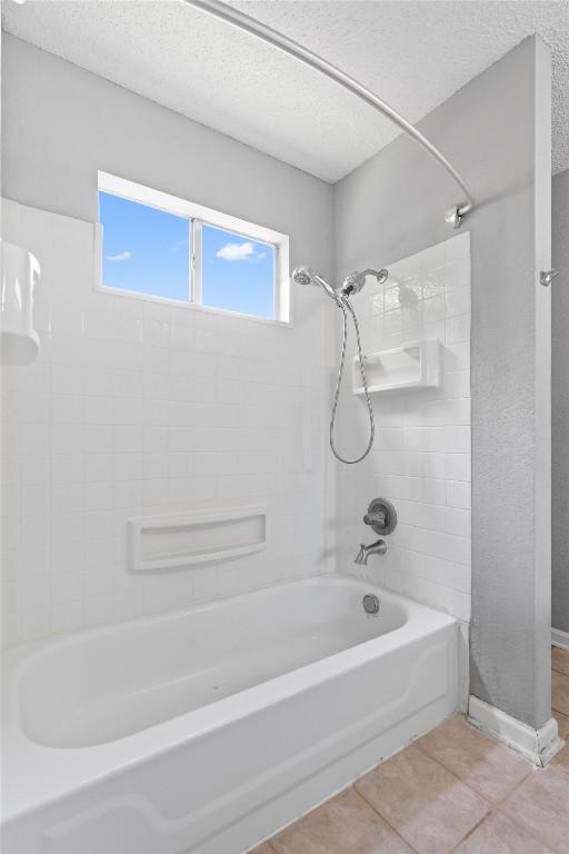 913 Dover Pass, Cedar Park, TX 78613 - full bathroom featuring tile patterned floors, washtub / shower combination, a textured ceiling, and baseboards