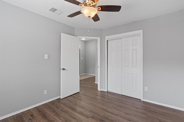 913 Dover Pass, Cedar Park, TX 78613 - unfurnished bedroom with wood finished floors, a closet, baseboards, and a ceiling fan