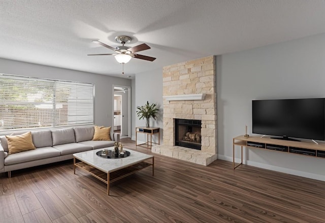 913 Dover Pass, Cedar Park, TX 78613 - living room with ceiling fan, wood finished floors, a stone fireplace, and baseboards