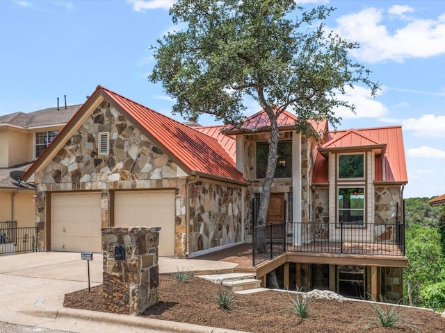 10110 Echoridge Dr, Austin, TX 78750 - view of front facade featuring stone siding, a standing seam roof, a metal roof, a garage, and driveway