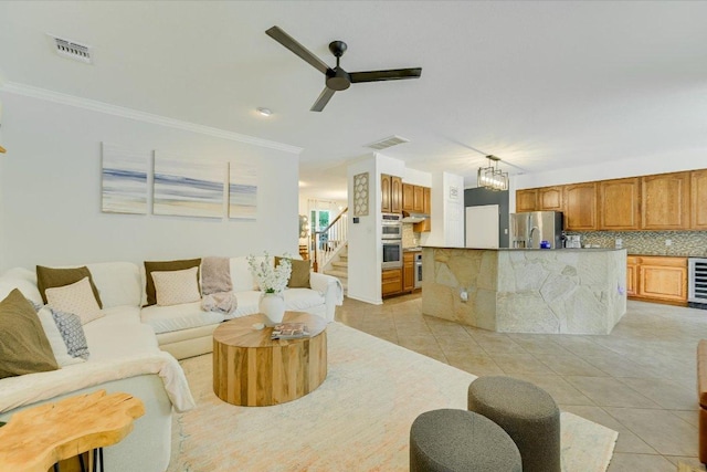 803 Crocus Dr, Cedar Park, TX 78613 - living area featuring light tile patterned flooring, a ceiling fan, ornamental molding, stairway, and wine cooler