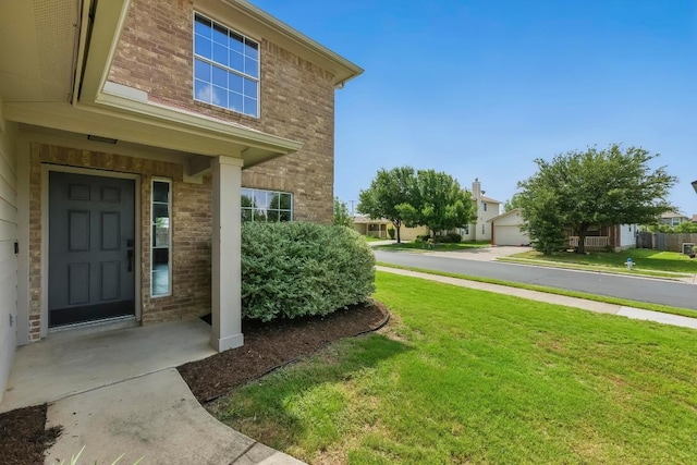 339 Precipice Way, Georgetown, TX 78626 - view of exterior entry with brick siding and a yard