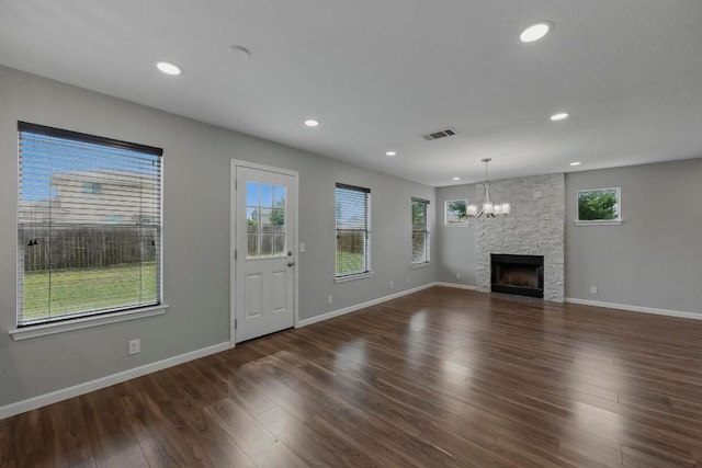 339 Precipice Way, Georgetown, TX 78626 - unfurnished living room with a chandelier, dark wood finished floors, baseboards, recessed lighting, and a fireplace
