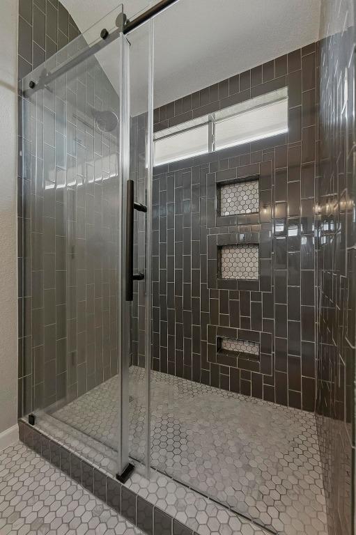 339 Precipice Way, Georgetown, TX 78626 - full bath featuring a stall shower and tile patterned floors