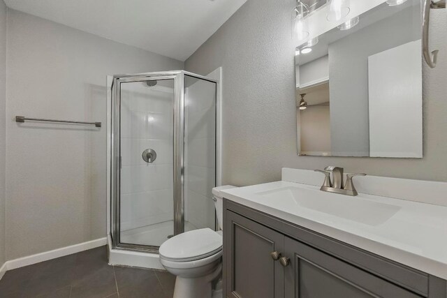 339 Precipice Way, Georgetown, TX 78626 - bathroom with a shower stall, vanity, toilet, tile patterned flooring, and lofted ceiling