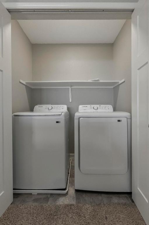 339 Precipice Way, Georgetown, TX 78626 - laundry room featuring washing machine and clothes dryer and tile patterned floors