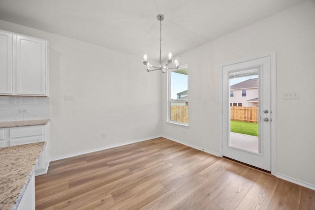 3917 Torraca Ln, Round Rock, TX 78665 - unfurnished dining area featuring a chandelier and light wood-type flooring