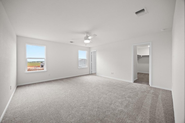 3917 Torraca Ln, Round Rock, TX 78665 - unfurnished bedroom with carpet flooring, a spacious closet, and a ceiling fan