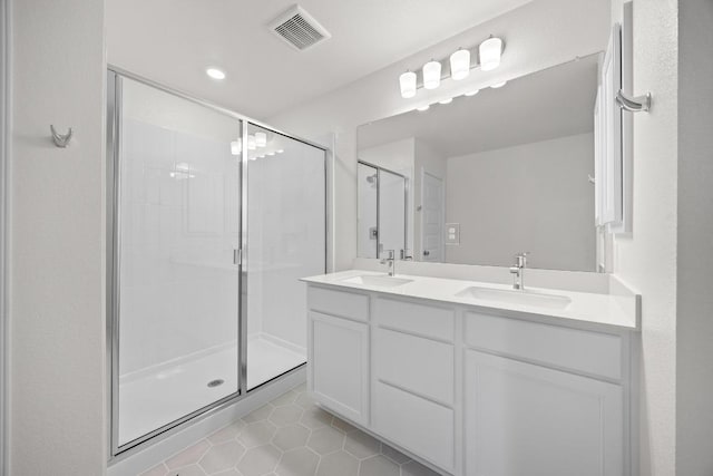 3917 Torraca Ln, Round Rock, TX 78665 - bathroom featuring a stall shower, tile patterned flooring, double vanity, and recessed lighting