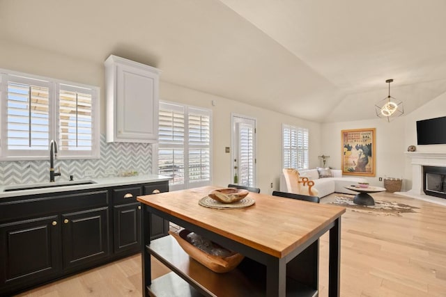 38 White Magnolia Cir, Austin, TX 78734 - kitchen with a sink, dark cabinets, wooden counters, white cabinetry, and light wood-style flooring