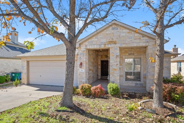 38 White Magnolia Cir, Austin, TX 78734 - view of front facade featuring a garage, stone siding, and driveway