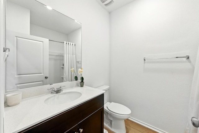 7506 Grenadine Bloom Bnd, Del Valle, TX 78617 - bathroom with vanity, wood finished floors, toilet, baseboards, and a shower with shower curtain