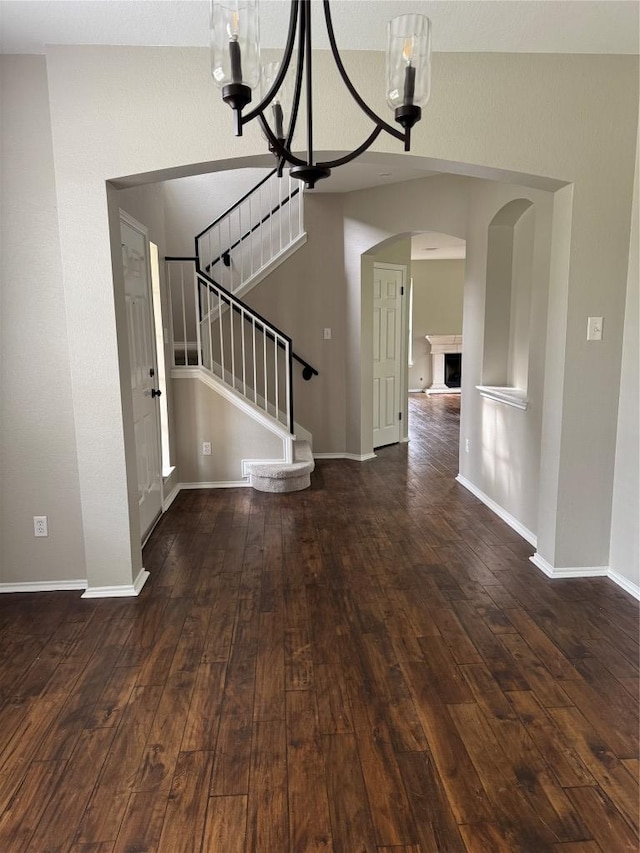 2606 Melba Pass, Cedar Park, TX 78613 - foyer featuring arched walkways, dark wood-type flooring, stairs, a chandelier, and baseboards