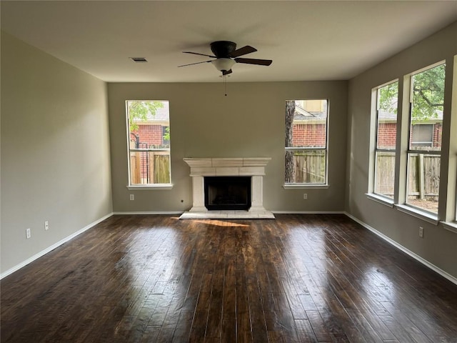 2606 Melba Pass, Cedar Park, TX 78613 - unfurnished living room with ceiling fan, hardwood / wood-style flooring, a fireplace with raised hearth, and baseboards
