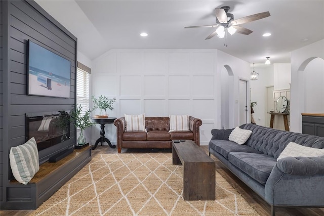 309 Callahan Ln, Leander, TX 78641 - living room featuring a decorative wall, ceiling fan, arched walkways, a large fireplace, and recessed lighting