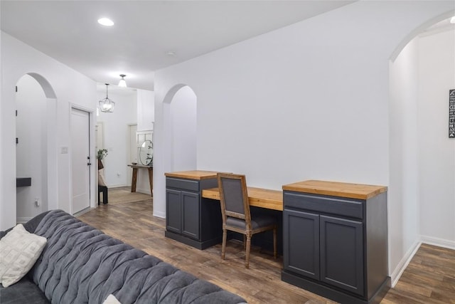 309 Callahan Ln, Leander, TX 78641 - living room featuring dark wood-type flooring, an office area, arched walkways, baseboards, and recessed lighting
