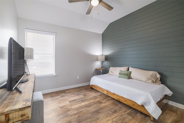 309 Callahan Ln, Leander, TX 78641 - bedroom featuring lofted ceiling, multiple windows, wood finished floors, baseboards, and a ceiling fan