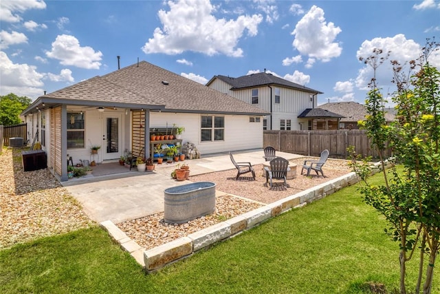 309 Callahan Ln, Leander, TX 78641 - rear view of property with a fire pit, a patio area, a shingled roof, and central air condition unit
