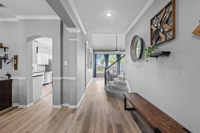120 Spring Ct, Georgetown, TX 78633 - hallway featuring arched walkways, light wood finished floors, ornamental molding, baseboards, and stairway