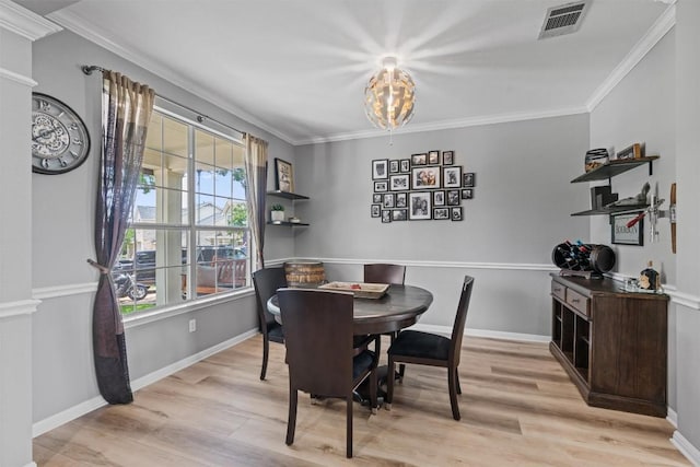 120 Spring Ct, Georgetown, TX 78633 - dining room with plenty of natural light, light wood-style flooring, a chandelier, crown molding, and baseboards